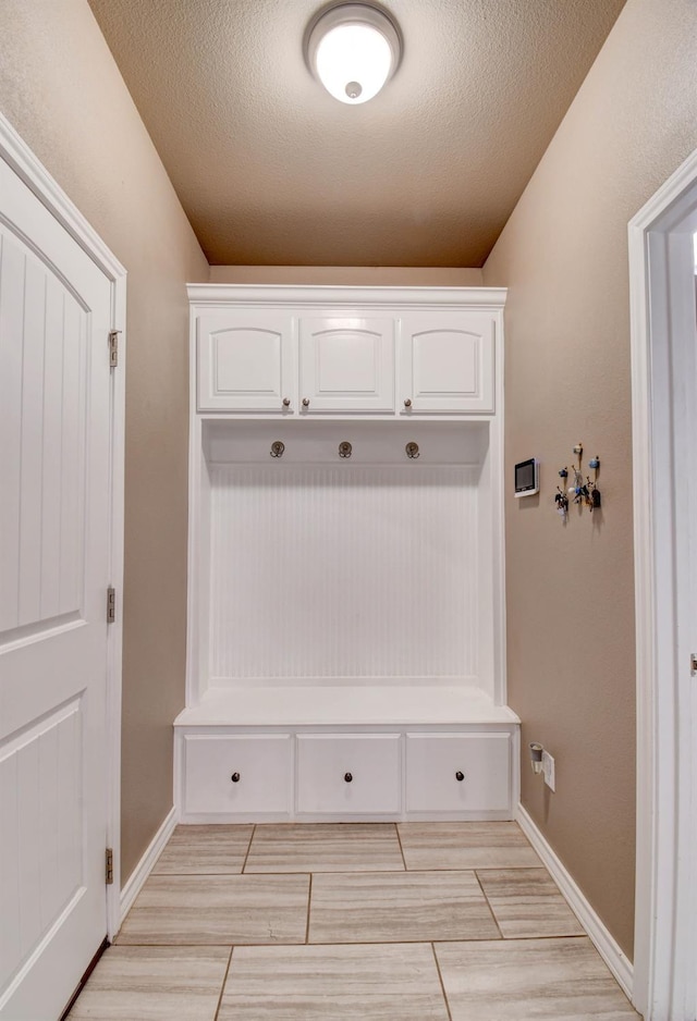 mudroom featuring a textured ceiling