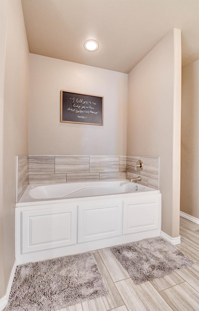 bathroom featuring a tub to relax in