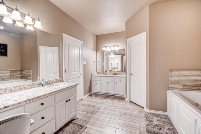 bathroom featuring vanity and a tub to relax in