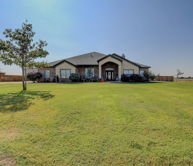 ranch-style home featuring a front yard