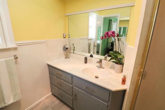 bathroom featuring a wainscoted wall and vanity