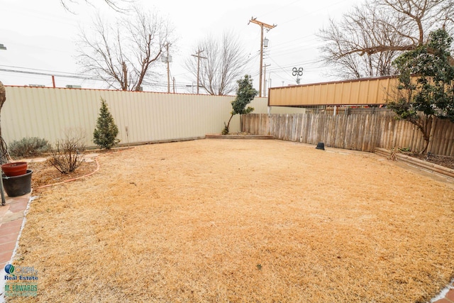 view of yard with a fenced backyard