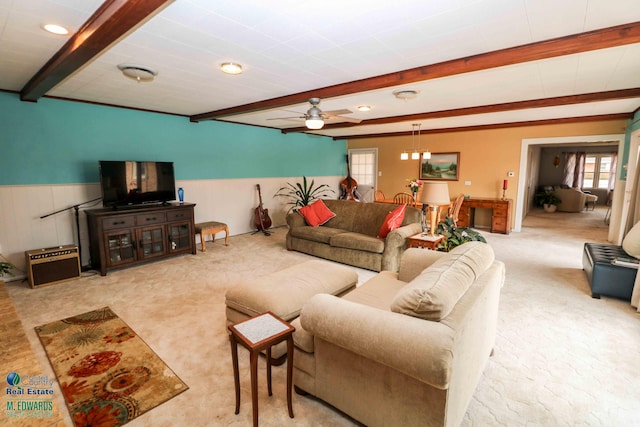 living room featuring light carpet, a wealth of natural light, beamed ceiling, and a wainscoted wall