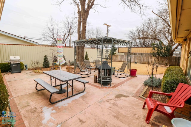 view of patio / terrace featuring an outdoor fire pit, outdoor dining area, area for grilling, and a fenced backyard