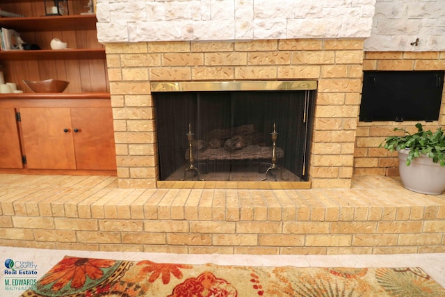interior details with a brick fireplace