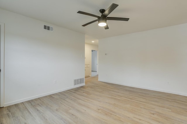 spare room with ceiling fan and light wood-type flooring