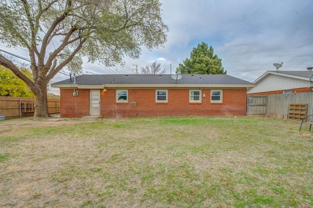 back of house with a lawn