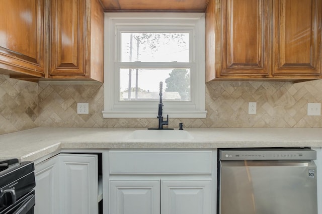 kitchen with black gas range oven, sink, tasteful backsplash, and dishwasher