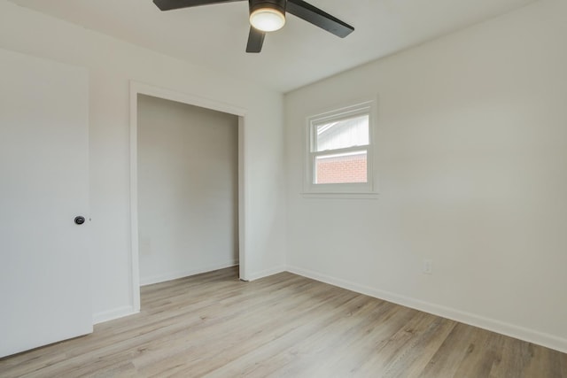 unfurnished bedroom featuring light wood-type flooring, ceiling fan, and a closet