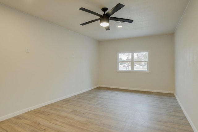 spare room featuring ceiling fan and light hardwood / wood-style flooring