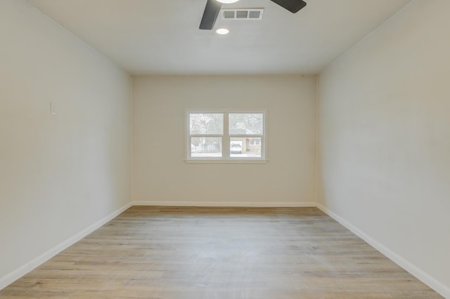 empty room featuring ceiling fan and light hardwood / wood-style flooring