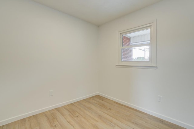 spare room with light hardwood / wood-style flooring