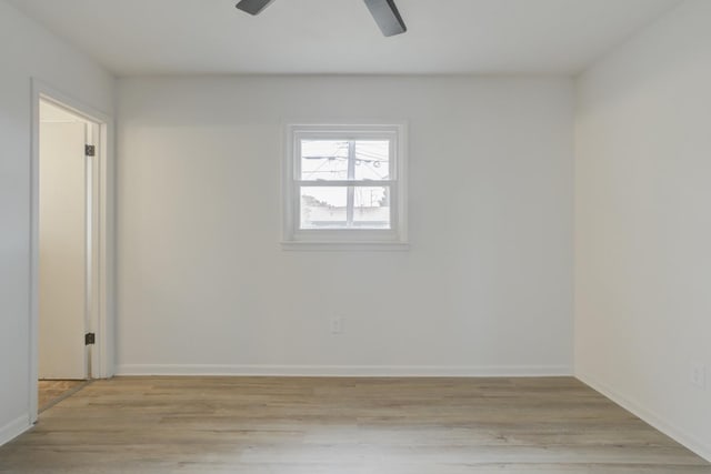 spare room with ceiling fan and light wood-type flooring