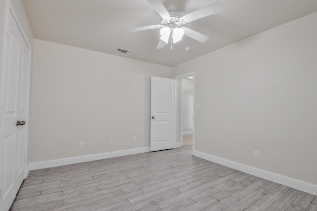 spare room with ceiling fan and light wood-type flooring