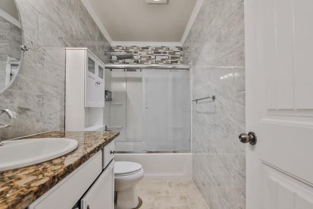 full bathroom with enclosed tub / shower combo, vanity, toilet, and tile walls