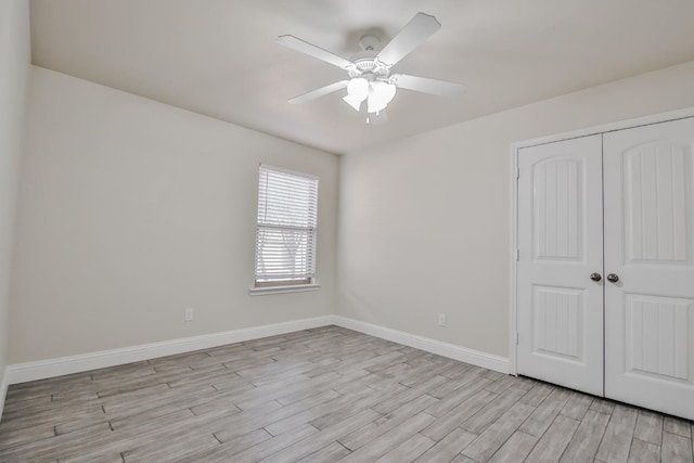 unfurnished bedroom featuring light hardwood / wood-style flooring, ceiling fan, and a closet