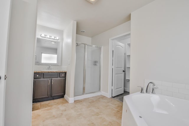 bathroom featuring tasteful backsplash, vanity, and separate shower and tub