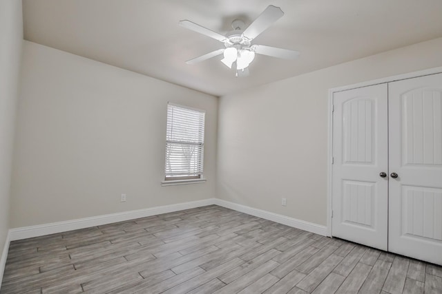 unfurnished bedroom featuring a closet, ceiling fan, and light wood-type flooring