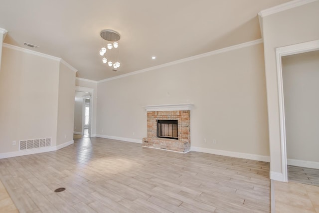 unfurnished living room featuring crown molding, a fireplace, and light wood-type flooring