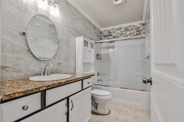 full bathroom with vanity, tile walls, shower / bath combination with glass door, and toilet