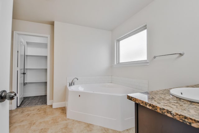 bathroom featuring vanity and a tub to relax in