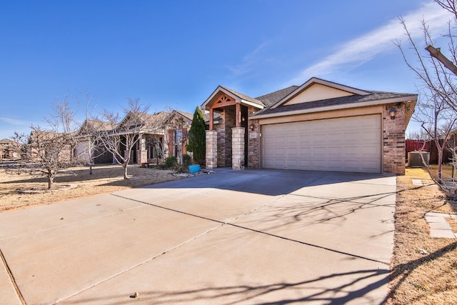 view of front of property with central AC unit and a garage