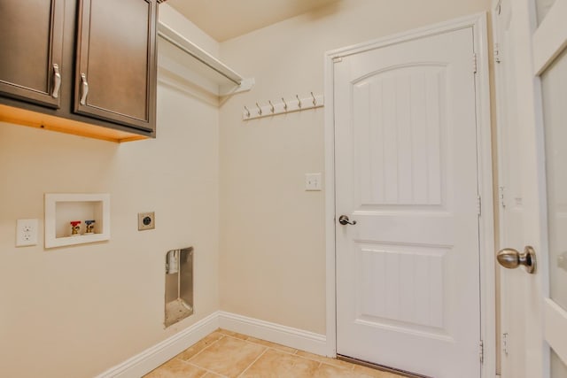 washroom with cabinets, light tile patterned flooring, washer hookup, and hookup for an electric dryer