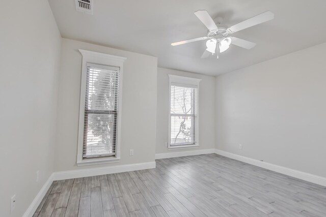 unfurnished room featuring ceiling fan and light wood-type flooring