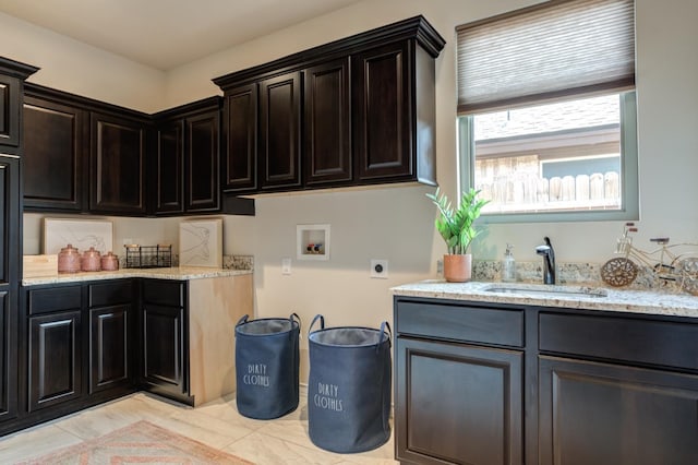 laundry area with cabinets, hookup for an electric dryer, sink, and washer hookup