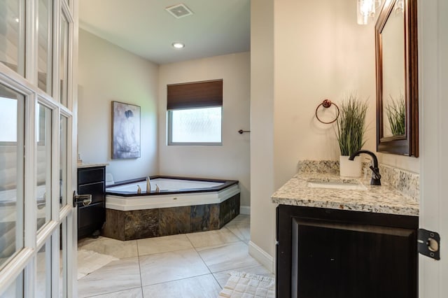 bathroom with vanity and tiled bath