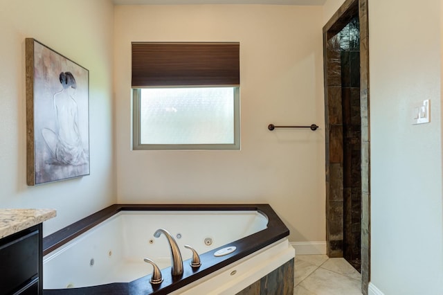 bathroom featuring vanity, tile patterned floors, and a tub