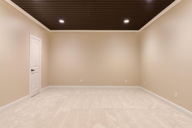 carpeted empty room featuring crown molding