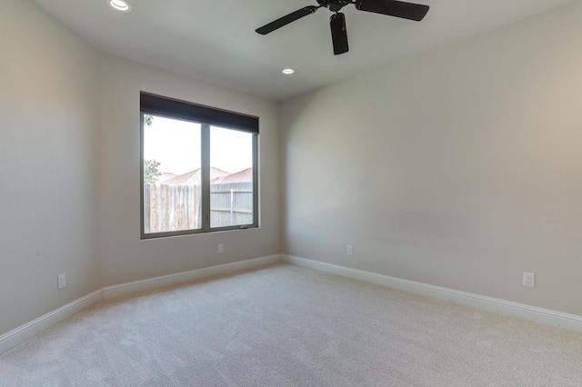 carpeted empty room featuring ceiling fan