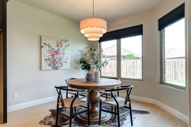 dining room with light wood-type flooring and a wealth of natural light