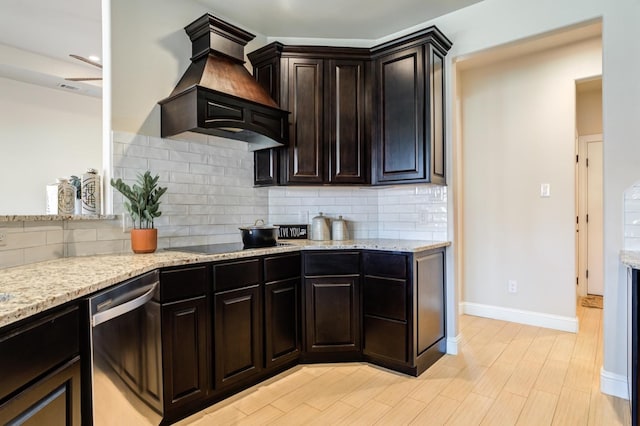 kitchen with light wood-type flooring, dishwasher, custom range hood, black electric stovetop, and decorative backsplash