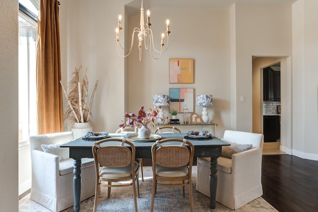 dining area featuring wood-type flooring and a notable chandelier