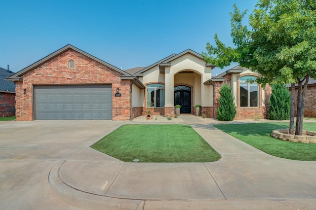 view of front facade with a garage and a front yard