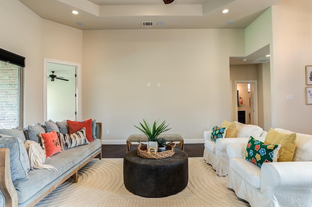 living room featuring wood-type flooring and ceiling fan