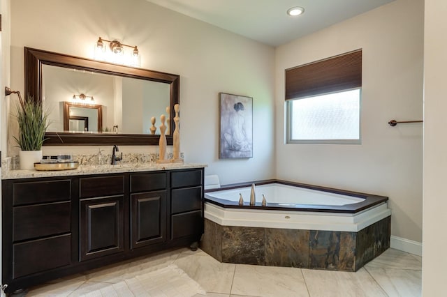 bathroom with vanity and tiled bath