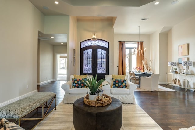 entryway with an inviting chandelier, wood-type flooring, and french doors