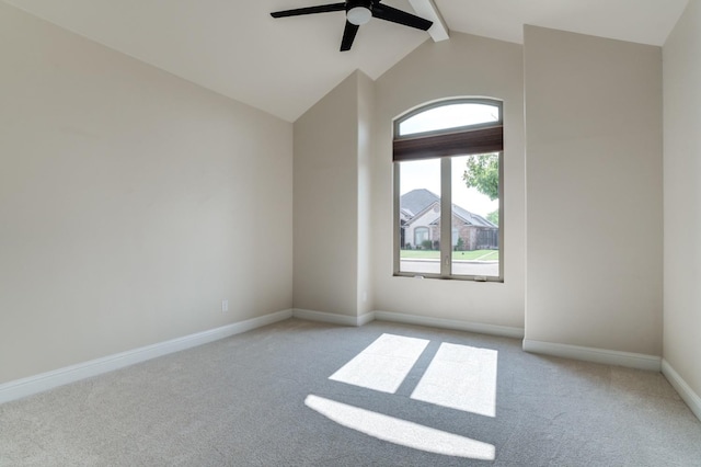 unfurnished room featuring ceiling fan, light colored carpet, and vaulted ceiling with beams