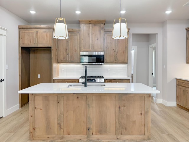 5811 Venita Ave, Lubbock, TX 79407 - kitchen with stainless steel microwave, light wood-style floors, decorative backsplash, light countertops, and recessed lighting