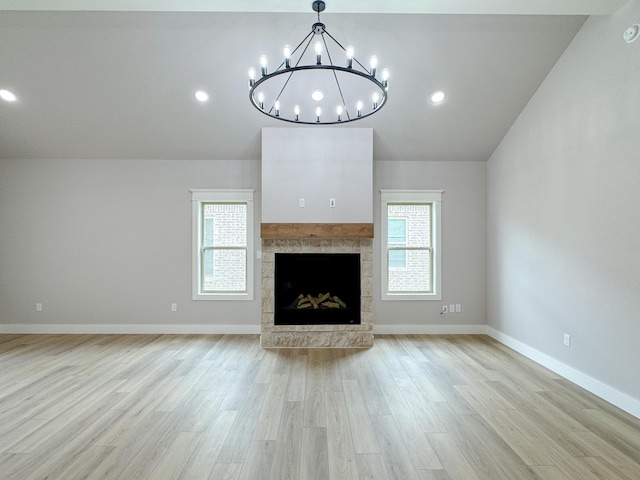 5811 Venita Ave, Lubbock, TX 79407 - unfurnished living room featuring a chandelier, light wood-style flooring, vaulted ceiling, a fireplace, and recessed lighting