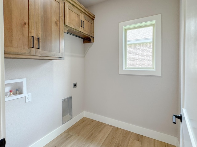 5811 Venita Ave, Lubbock, TX 79407 - laundry room with hookup for an electric dryer, cabinet space, light wood finished floors, and washer hookup