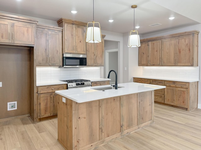 5811 Venita Ave, Lubbock, TX 79407 - kitchen with appliances with stainless steel finishes, light wood finished floors, tasteful backsplash, an island with sink, and light countertops
