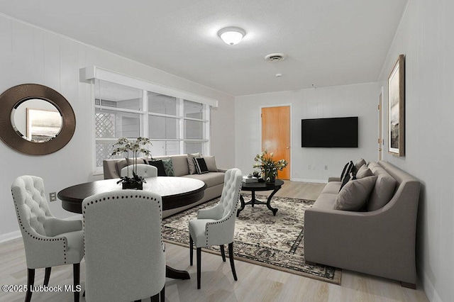 1606 E Cardwell St, Brownfield, TX 79316 - living room with baseboards, wood finished floors, and visible vents