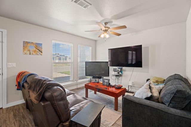 living room featuring ceiling fan and light wood-type flooring