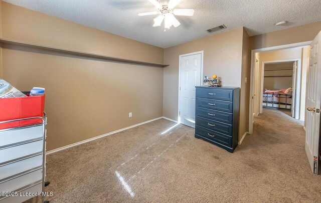 401 Oshkosh Ave, Lubbock, TX 79416 - carpeted bedroom with a textured ceiling and ceiling fan