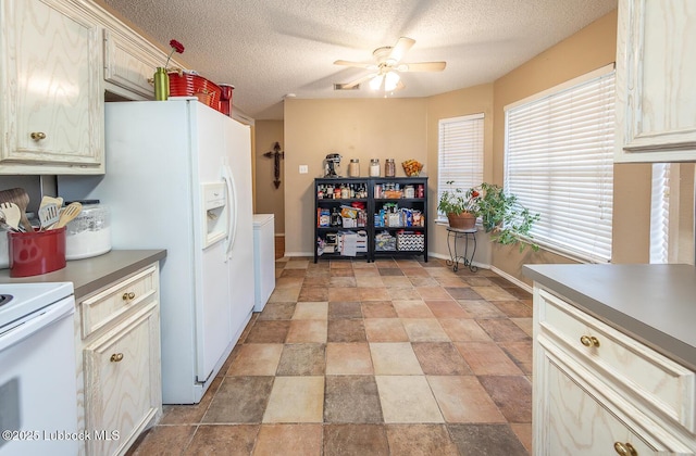 401 Oshkosh Ave, Lubbock, TX 79416 - kitchen with white appliances, washer / clothes dryer, a ceiling fan, stone finish flooring, and a textured ceiling