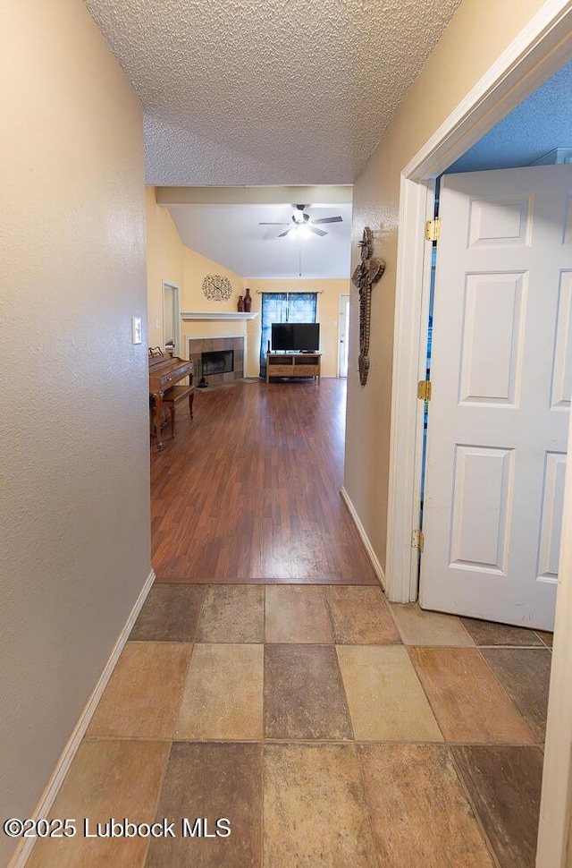 401 Oshkosh Ave, Lubbock, TX 79416 - hallway with a textured ceiling, stone finish floors, and lofted ceiling